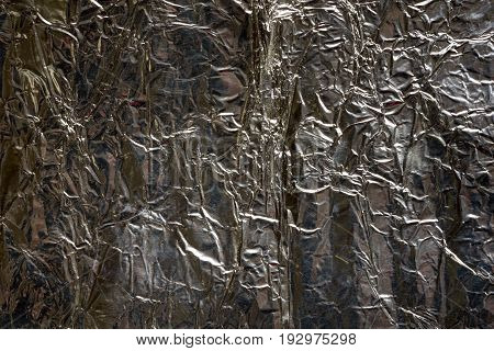 dark silver crumped foil close up background texture