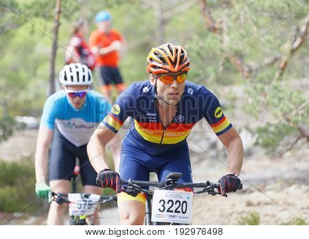 STOCKHOLM SWEDEN - JUNE 11 2017: Closeup of group of mountain bike cyclists in the forest at Lida Loop Mountain bike Race. June 11 2017 in Stockholm Sweden