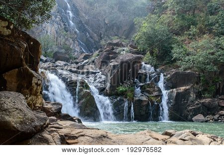 Lodh waterfall with sun rays in Jharkhand,India. Lens flare and light leak.