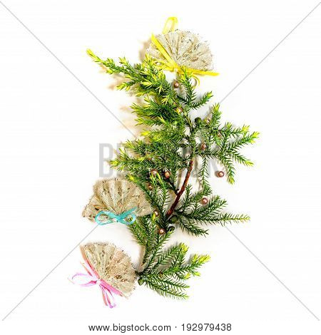 flat lay small christmas tree made from fir branches decorated with three fans isolated on white background. new year and christmas concept of spanish mexican or chinese culture.