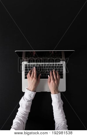 Cropped Shot Of Woman Working On Laptop Isolated On Black
