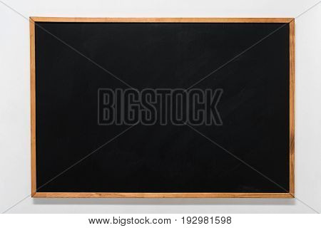 empty school blackboard in wooden frame with copy space