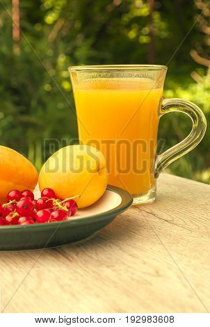 glass of fresh juice and fresh fruit