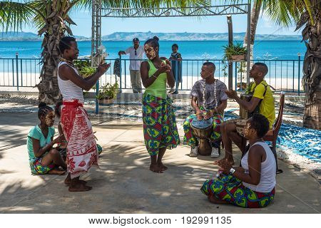 Ramena Madagascar - December 20 2015: Malagasy folk musicians and dancers in the fishing village of Ramena Madagascar. Sakalava young women with his traditional beauty mask.