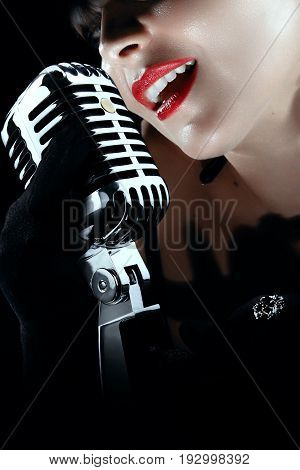 girl subrette singing with a 50th age mic