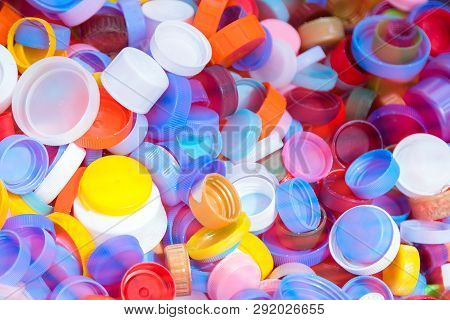 Pile Of Plastic Bottle Caps Texture. A Lot Of Bottle Tops Of Soft Drinks, Plastic Recycling