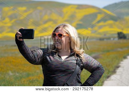 Cute Blond Woman Wearing Sunglasses Takes Selfies At Carrizo Plain National Monument During The Cali