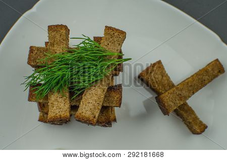 Toasts Are Fried On A Frying Pan With Spices. Served On A White Plate With Garlic Sauce And Barbecue