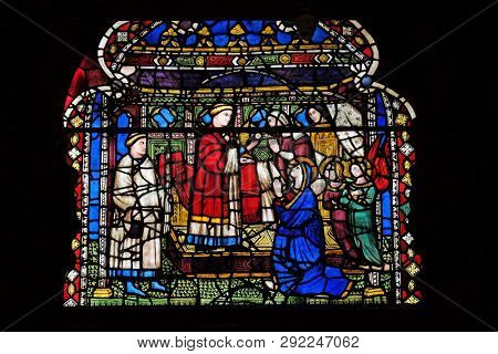 FLORENCE, ITALY - JANUARY 09, 2019: The Last communion with a dying by Niccolo di Piero Tedesco, 1380., stained glass window in Orsanmichele Church in Florence, Tuscany, Italy