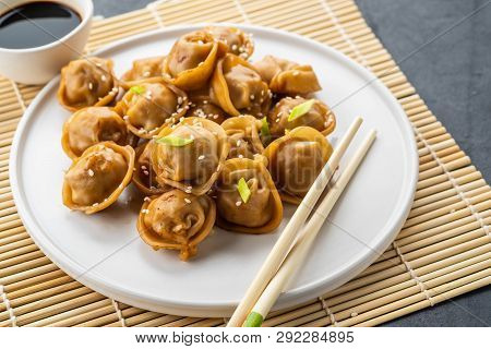 Home Made Chinese And Korean Dumplings Served On The Traditional Steamer And Bamboo Mat Decorated Wi