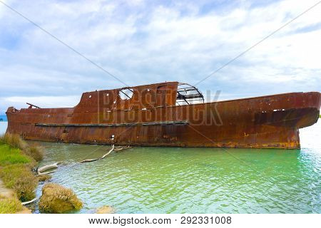 Scuttled Rusting Hulk Of Old Ship Waverley In Shallows Of Wairau Lagoons On Nature Walk.