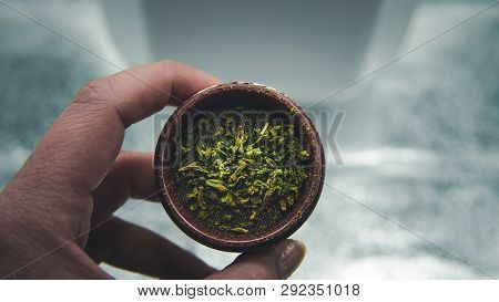 The Person Holds In His Hands Weed In Grinder. Marijuana Is Medical.