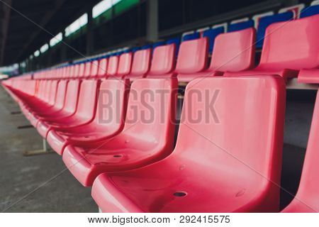 The Old Shabby Empty Red Seats At The Stadium. One Seat Is New In A Row Of Old Seats.