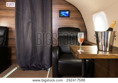A Glass Of Champagne In The Interior Of A Private Jet. Flying First Class