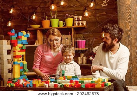 Building Concept. Little Son With Mother And Father Play With Building Blocks. Building Social Skill