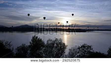 Hot Air Balloons Flying In The Air Above Lake Burley Griffin, As Part Of The Balloon Spectacular Fes