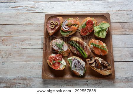 Brushetta Or Traditional Spanish-tapas. Appetizers With Italian Antipasti Snacks. Variety Of Small S