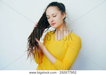 Beautiful Girl With Dreadlocks And In A Yellow Bright Sweater Keep Your Dreadlocks And Stroking Them
