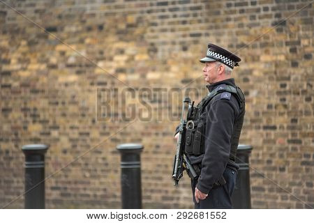 Armed British Police Officer On Duty