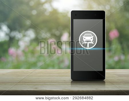 Service Fix Car With Wrench Tool Icon On Modern Smart Mobile Phone Screen On Wooden Table Over Blur 