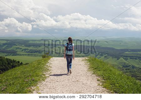 The Girl Goes To The Horizon Against The Sky