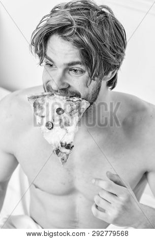 Man Bearded Handsome Bachelor Eating Cheesy Food For Breakfast In Bed. Handsome Man Holds A Piece Of