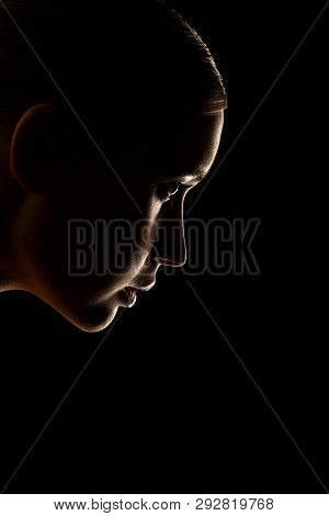 Sad Woman Profile Silhouette On Black Background Looking Down