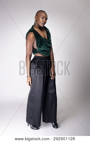 Black African American Female Fashion Model Posing With Trendy Bald Hairstyle And Stylish Clothing I