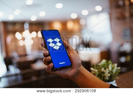 Chiang Mai, Thailand - Mar. 24,2019: Man Holding Xiaomi Mi Mix 3 With Dropbox On Screen.dropbox Is A