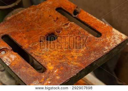 An Iron Plate With Holes Covered With A Thick Layer Of Rust That Eats Away Metal