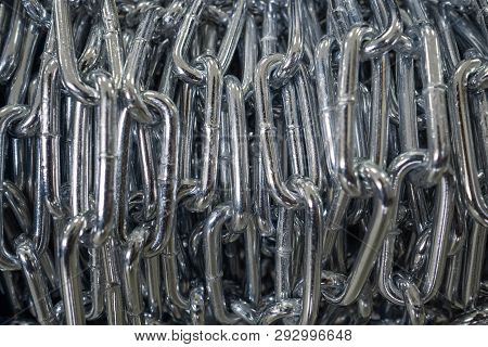 The Steel Chain Is Reeled Up On The Coil In Shop. The Brilliant Chain Twisted In A Roll. Long Indust