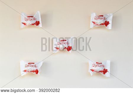 Raffaello Candies On Beige Background. Raffaello Is A Spherical Coconut Almond Confection That Itali