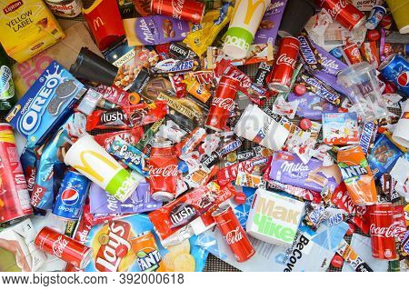 Many Wrappings And Cans From Used Products By Famous Worldwide Brands. Pattern Of Trash Of Various C