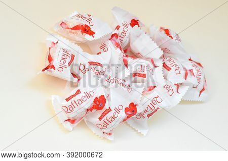 Raffaello Candies On Beige Background. Raffaello Is A Spherical Coconut Almond Confection That Itali
