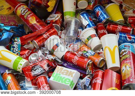 Many Wrappings And Cans From Used Products By Famous Worldwide Brands. Pattern Of Trash Of Various C