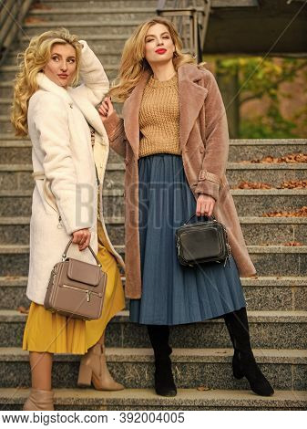 No Cares. European Winter. Girls Warm Coat On Stairs. Faux Fur Coat Fashion. Stylish Business Ladies