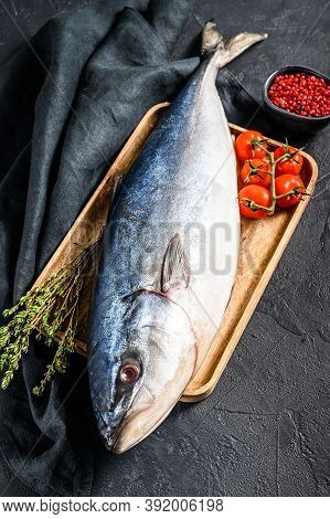 Fresh Whole Japanese Amberjack. Raw Fish Yellowtail. Black Background. Top View