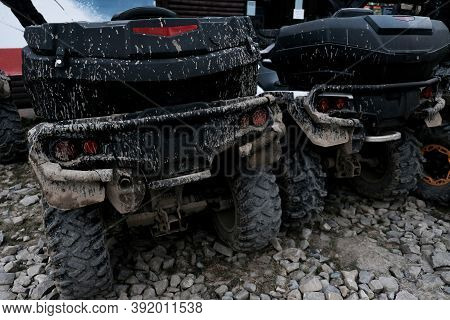 Back View Of Two Dirty Muddy Quad Bikes. Off-road Extreme Transportation For Adventurous Lifestyle. 