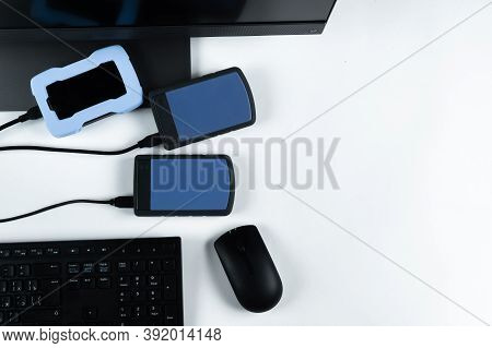 Multiple External Hard Drives Connected To A Monoblock On A White Background.computer With Hard Driv