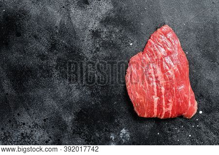 Raw Flat Iron Steak. Marble Beef Black Angus. Black Background. Top View. Copy Space