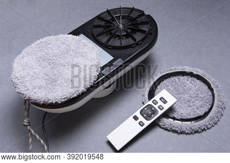 Downside Of Disassembled Vacuum Cleaner Robot For Washing Glass Window On Gray Background. Robot Ass