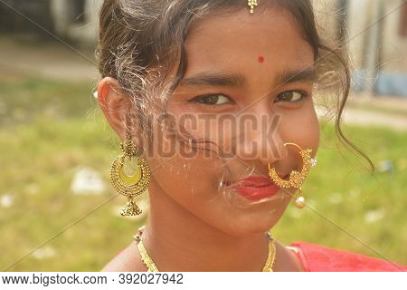 Close Up Of An Indian Bengali Teenage Girl Wearing Indian Traditional Jewellery Like Nose Ring, Ear 
