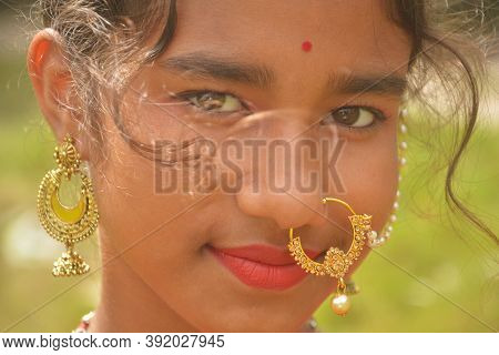Close Up Of An Indian Bengali Teenage Girl Wearing Indian Traditional Jewellery Like Nose Ring, Ear 