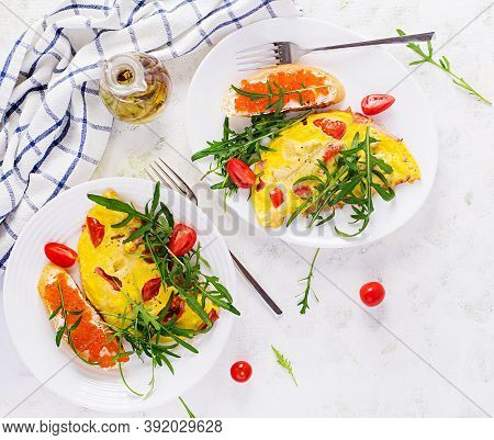 Omelette With Tomatoes, Cheese, Ham And Sandwich Wich Red Cavier On Plate.  Frittata - Italian Omele