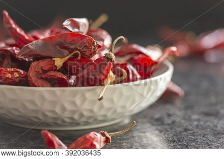 Dried Red Chili Or Chilli Cayenne Pepper In Grey Bawl On Black Marble Background, Close Up
