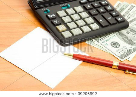 Pen, Calculator And Money on desk