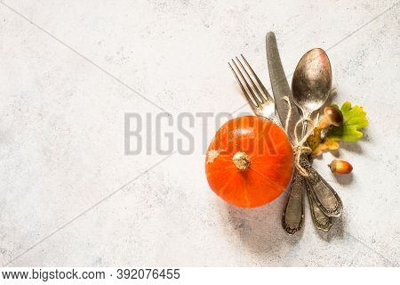 Fall Table Setting With Silverware And Fall Decorations At White Table. Top View With Copy Space.