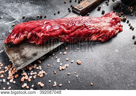 Raw Strip Vegas Steak On A Meat Cleaver. Black Background. Top View