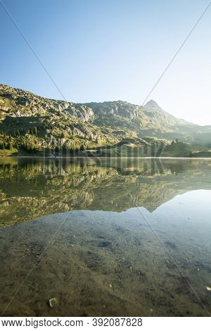 Scenic Bettmer Lake Near Fiesch In Wallis, Switzerland. Reflection On The Lake At Sunrise