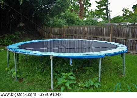 Dangerous Live Downed Power Line Draped Across Fence And Trampoline
